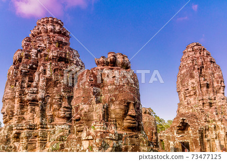Stone Reliefs head on towers at the Bayon Temple in Angkor Thom 73477125