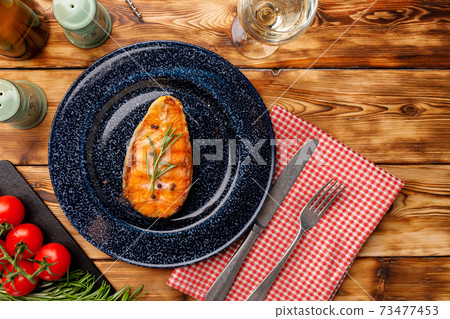 Grilled salmon steak on blue plate on wooden table Grilled salmon steak on blue plate on wooden table 73477453