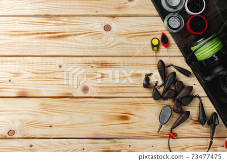 Fishing gear on wooden background close up Fishing gear on wooden background close up 73477475