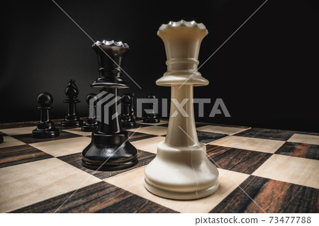 Chess board with figures on dark background Chess board with figures on dark background 73477788