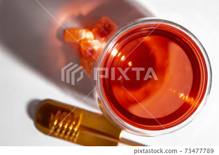 Glass cup of tea on blue background Glass cup of tea on blue background 73477789