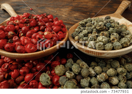 Pile of peppercorn on wooden table macro Pile of peppercorn on wooden table macro 73477931