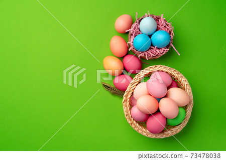 Easter eggs in a nest on green background Easter eggs in a nest on green background 73478038