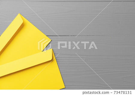 Yellow envelope on gray background top view Yellow envelope on gray background top view 73478131