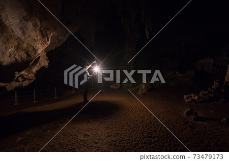 Female explorers in cave. Female explorers in cave. 73479173
