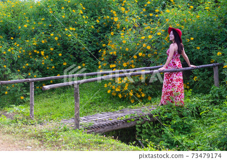 Beautiful woman in nature flower. Beautiful woman in nature flower. 73479174