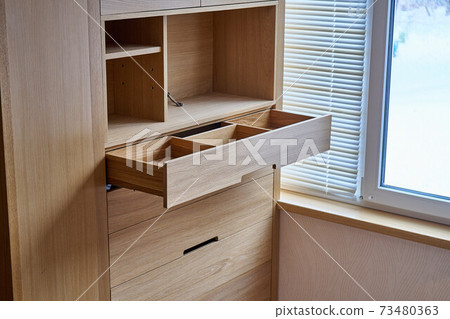 Wooden cupboard with opened drawer. Modern furniture Wooden cupboard with opened drawer. Modern furniture 73480363