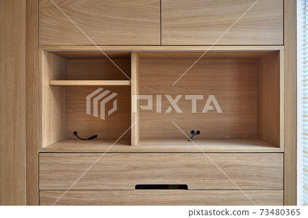 Wooden cupboard with drawers and empty shelves. Modern furniture Wooden cupboard with drawers and empty shelves. Modern furniture 73480365
