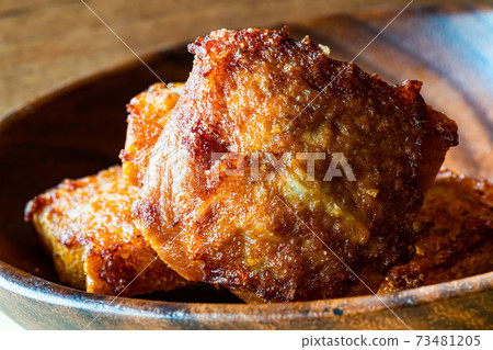Closeup of fried minced pork toast in wooden bowl on wooden table. Closeup of fried minced pork toast in wooden bowl on wooden table. 73481205