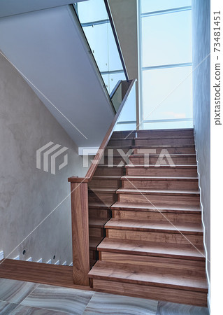 Part of wooden steps with glass railings. Walnut staircase Part of wooden steps with glass railings. Walnut staircase 73481451