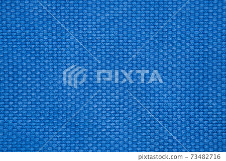The texture of a cotton kimono for judo classes. Blue fabric close-up. The view from the top. The texture of a cotton kimono for judo classes. Blue fabric close-up. The view from the top. 73482716