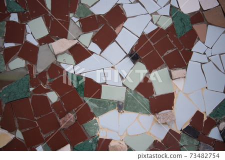 Background of pieces of colored tiles. Texture and structure. An abstract pattern. 73482754