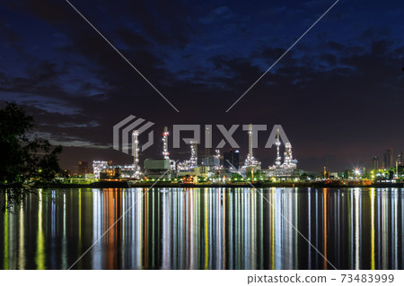 Oil and gas refinery plant factory with refection on river at night twilight. petrochemical and energy industry concept. 73483999