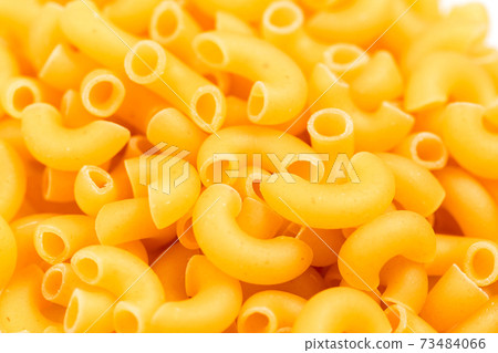 Raw Italian pasta in a heap on the table. Raw Italian pasta in a heap on the table. 73484066