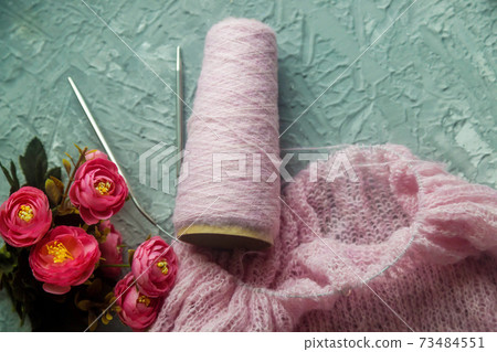 Knitting background flatlay.Kknitted pullover on a concrete background. Knitting background flatlay.Kknitted pullover on a concrete background. 73484551
