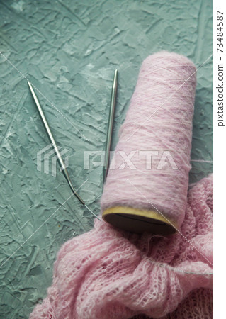 Knitting background flatlay.Kknitted pullover on a concrete background. Knitting background flatlay.Kknitted pullover on a concrete background. 73484587