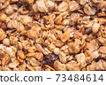 Useful and tasty muesli with nuts, rasins and flakes. Selective focus macro shot with very shallow depth of field. Healthy and vegetarian lifestyle 73484614