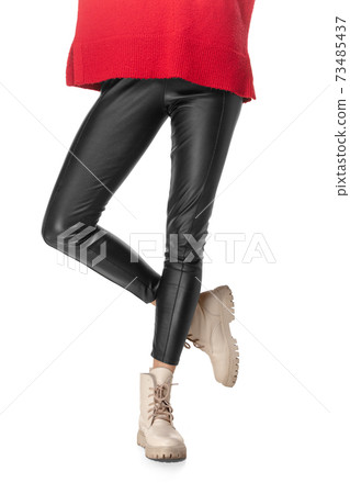 Slim legs of young girl in black leggings and boots isolated on white background 73485437