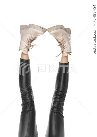 Beautiful long slim female legs in stylish boots isolated on white background Beautiful long slim female legs in stylish boots isolated on white background 73485454