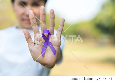 Pancreatic Cancer, world Alzheimer, epilepsy, lupus and domestic violence day Awareness month, Woman holding purple Ribbon for supporting people living. Healthcare and World cancer day concept Pancreatic Cancer, world Alzheimer, epilepsy, lupus and domestic violence day Awareness month, Woman holding purple Ribbon for supporting people living. Healthcare and World cancer day concept 73485471
