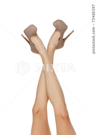 Attractive long slim female legs in stylish shoes isolated on white background 73486397