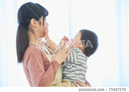 Smiley child and nursery teacher Smiley child and nursery teacher 73487570