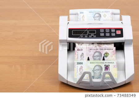 Angolan money - Kwanza a new series of banknotes in the counting machine Angolan money - Kwanza a new series of banknotes in the counting machine 73488349