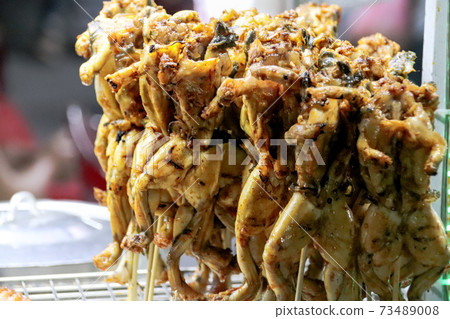 Grilled frog sold as traditional street food in Cambodia 73489008