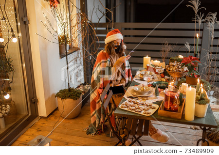 Woman on self-isolation celebrating New Year holidays at home Woman on self-isolation celebrating New Year holidays at home 73489909
