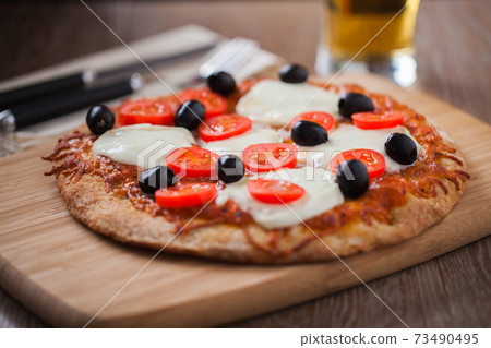 Pizza with Fresh Cheese, Cherry Tomatoes and Olives and Beer Pizza with Fresh Cheese, Cherry Tomatoes and Olives and Beer 73490495