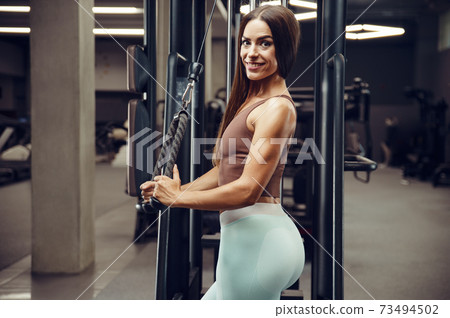 fitness woman pumping up butt booty legs muscles 73494502