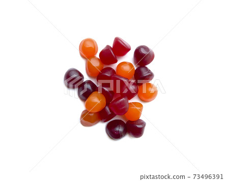 Group of red, orange and purple multivitamin gummies isolated on white background. Healthy lifestyle concept.. Group of red, orange and purple multivitamin gummies isolated on white background. Healthy lifestyle concept.. 73496391