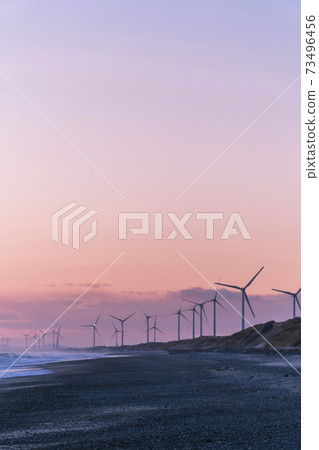 A group of wind power generators at sunset on the Hamaoka sand dunes and beaches along the sea in Omaezaki City, Shizuoka Prefecture A group of wind power generators at sunset on the Hamaoka sand dunes and beaches along the sea in Omaezaki City, Shizuoka Prefecture 73496456