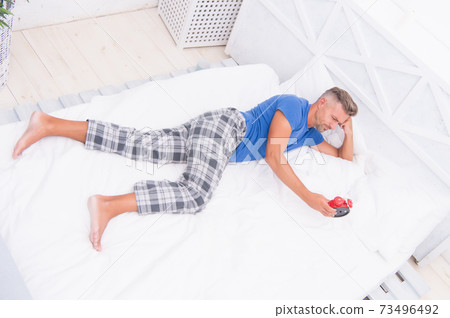 Sleeping guy at home. Sleep disorders. Good and healthy 73496492