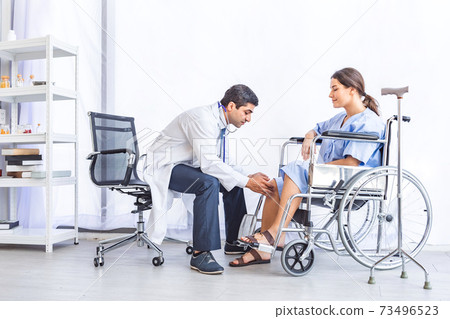 Asian doctor give advice and examination about knee joint for pretty patient at hospital or medical clinic Asian doctor give advice and examination about knee joint for pretty patient at hospital or medical clinic 73496523
