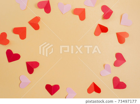 Valentine's Day background. Pink and red hearts on a pastel yellow background. Valentine's Day concept. Flat lay, top view, copy space Valentine's Day background. Pink and red hearts on a pastel yellow background. Valentine's Day concept. Flat lay, top view, copy space 73497177
