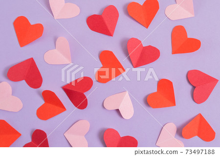 Valentine's Day background. Pink and red hearts on a pastel purple background. Valentine's Day concept. Layout for postcards and congratulations. Flat lay, top view, copy space Valentine's Day background. Pink and red hearts on a pastel purple background. Valentine's Day concept. Layout for postcards and congratulations. Flat lay, top view, copy space 73497188