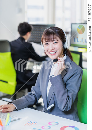 Young woman working in a call center Young woman working in a call center 73497997