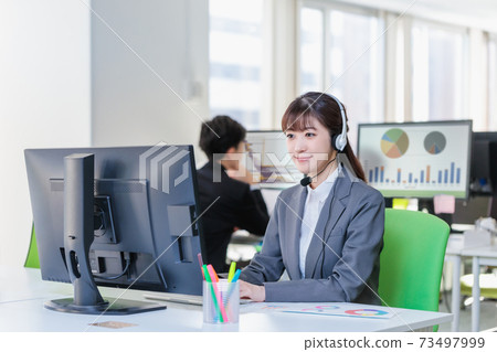 Young woman working in a call center Young woman working in a call center 73497999