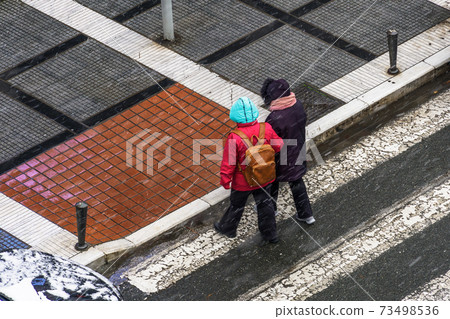 Thessaloniki, Greece Crowd on heavy snowfall at the city center. Thessaloniki, Greece Crowd on heavy snowfall at the city center. 73498536