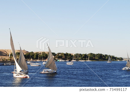 Cruising along the Nile river on Felucca boats, Nile, Egypt Cruising along the Nile river on Felucca boats, Nile, Egypt 73499117