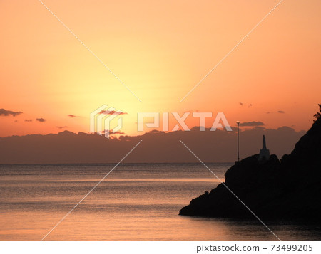 The statue of Mary on the sea that emerges in the evening view 73499205