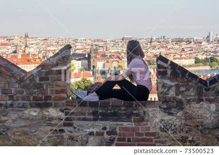 Person in front of Prague panorama charles bridge river from mountain skyview 73500523