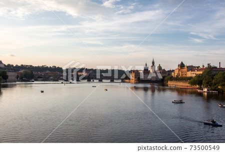 Charles bridge prague sunset light beautiful river water panoramic view 73500549