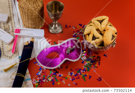 Hamans ears cookies for Purim Jewish holiday celebration noisemaker and mask carnival kosher wine 73502114