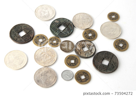 Old coins on a white background 73504272