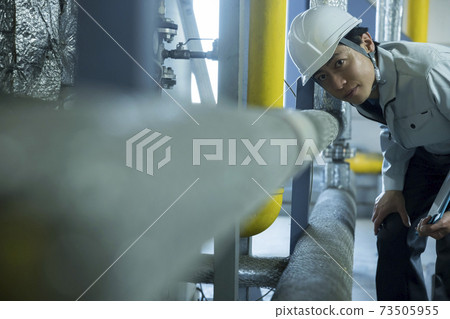 Male worker inspecting the factory Male worker inspecting the factory 73505955