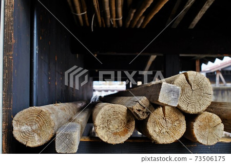 Log sticks stored in a barn Log sticks stored in a barn 73506175