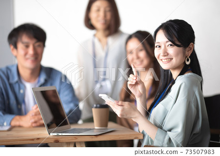 Business woman using a smartphone in the office 73507983