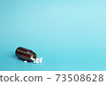 Various medicine. White round pills and pill bottle 73508628